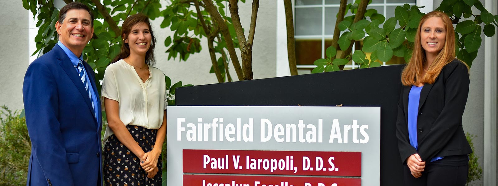 Fairfield Dental Arts staff next to the Fairfield Dental Arts sign, Jeannine Donahue on the right and Jessalyn Forella on the left.