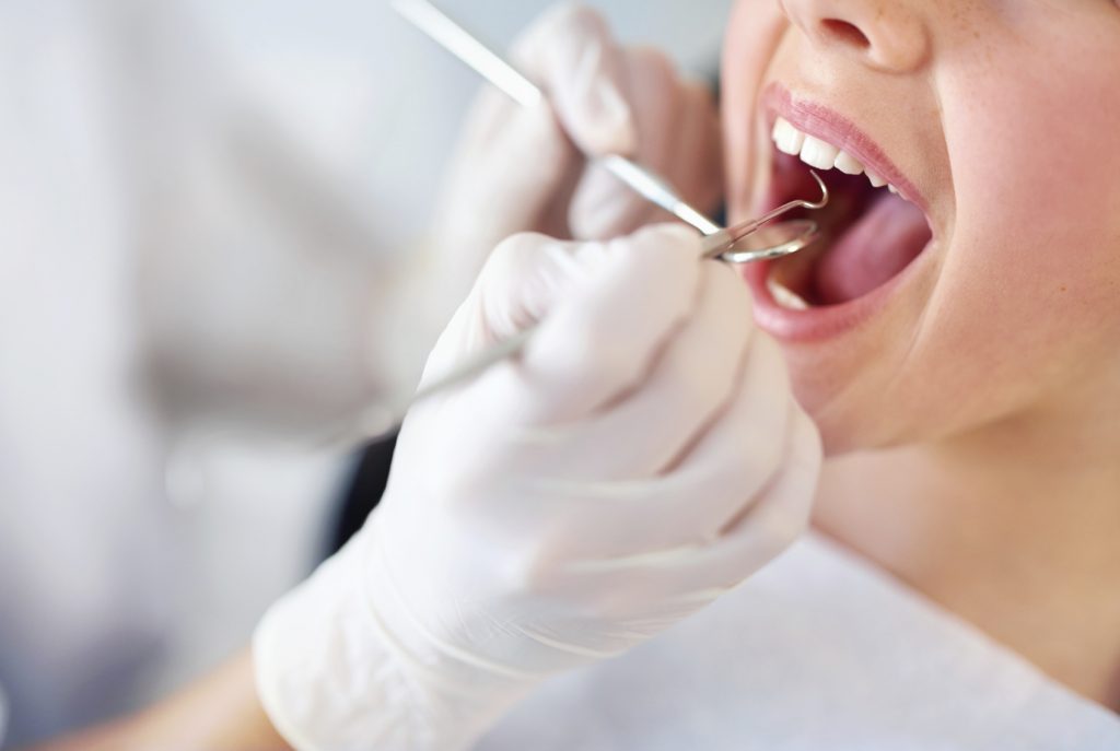 young girl having a checkup at the dentist