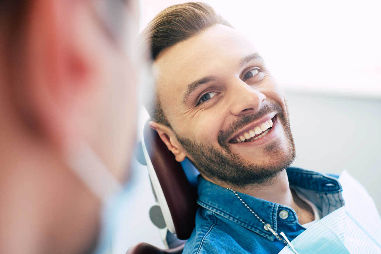 Man smiling at dentist after treatment