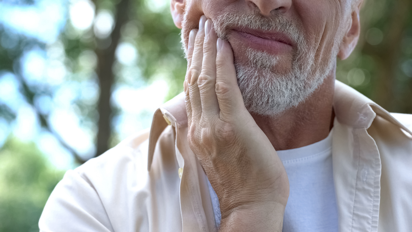 Senior man having problem with teeth