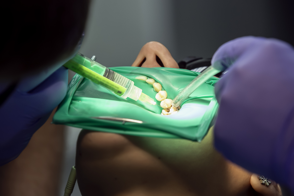 Dentist injecting anesthetic into mans tooth