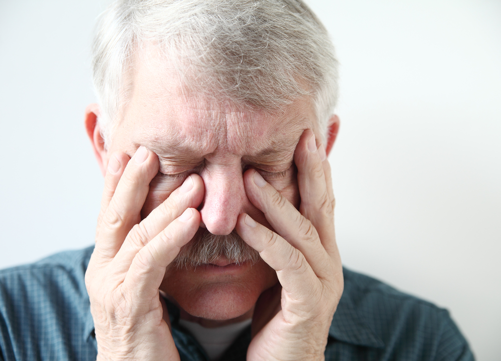 Man in pain with hands on head