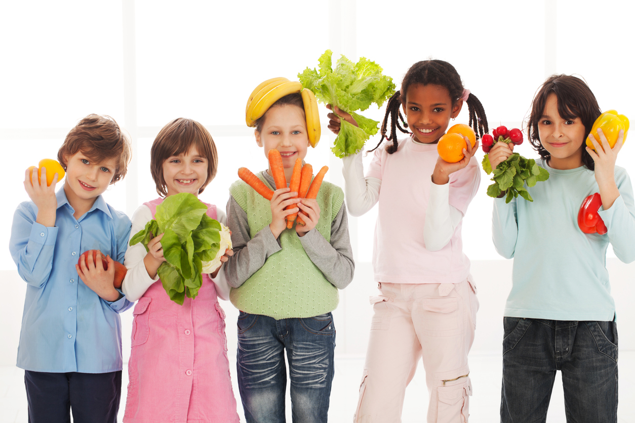 kids holding healthy fruits and vegetables